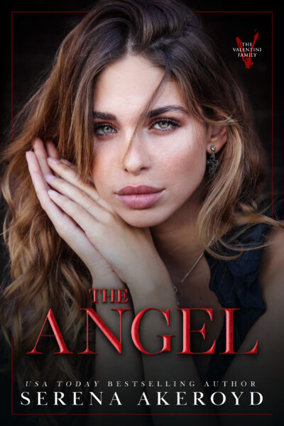A beautiful woman with brown to blonde ombre hair with her hands pressed together against the side of her face. She is wearing a black ruffled tank top style blouse. Text reads: The Angel, USA Today Bestselling Author Serena Akeroyd